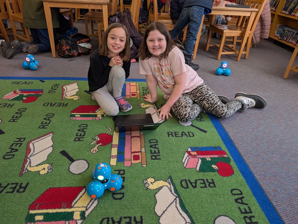 Pairings of students participating in a Robotics activity with Dash and Dot Robots. Each photo has two students and the laptop they're using to  program the robots. 