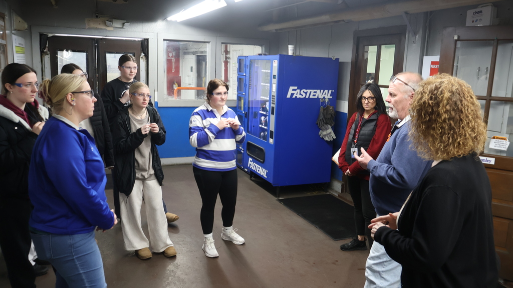 An International Wire staff member leads Mrs. Dacey's group through a factory tour at International Wire