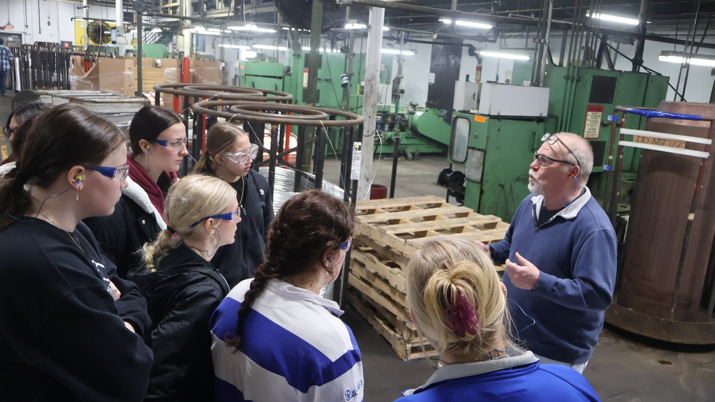 An International Wire staff member leads Mrs. Dacey's group through a factory tour at International Wire