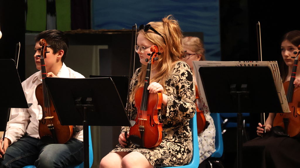 The CMS Orchestra - A student in ready position with her violin Music In Our Schools Month Concert - Grades 7/8 - 2026 