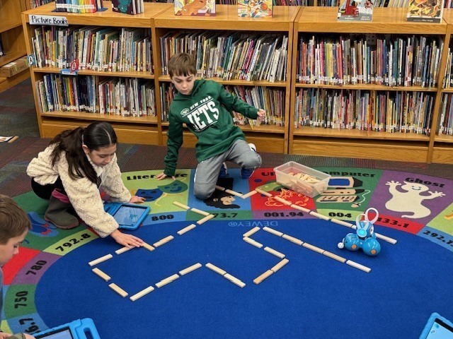 McConnellsville Coding Club Students Working On A Robotics Easter Egg Hunt In The Library
