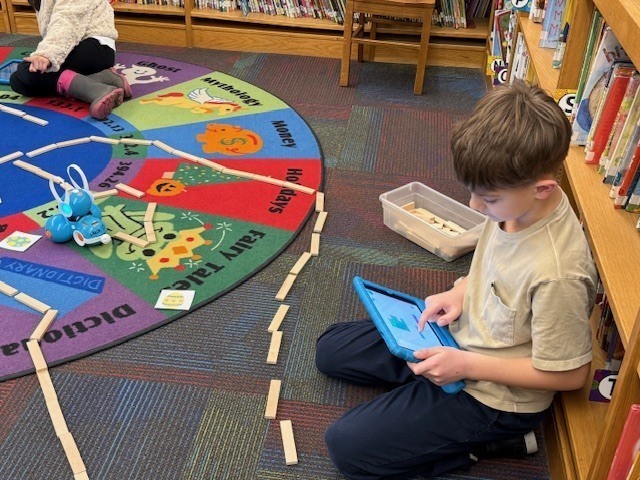 McConnellsville Coding Club Students Working On A Robotics Easter Egg Hunt In The Library