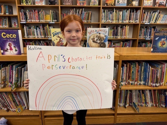 Student Holding Perseverance Poster