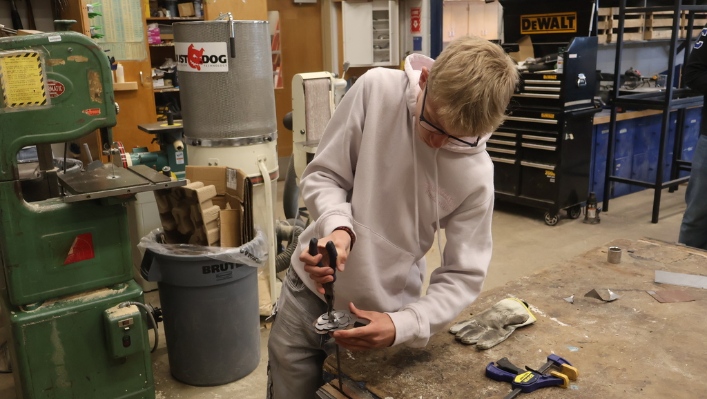 A student starts the process of bending a flower into shape
