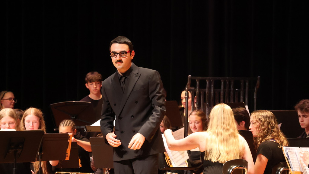 Larry Fiume takes a bow after conducting the orchestra