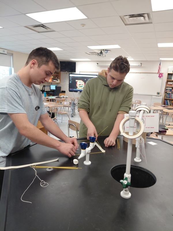 Science Building Challenge - Two Students Working On Their Structure