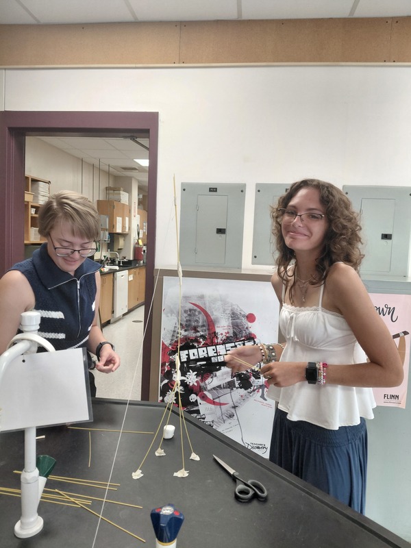 Science Building Challenge - Two Students Working On Their Structure