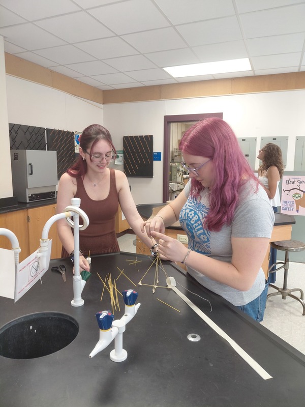 Science Building Challenge - Two Students Working On Their Structure