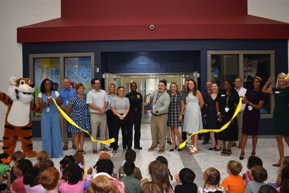 Admin cutting the ribbon