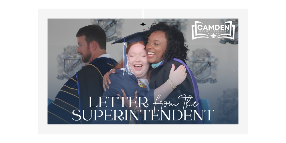 Photo of Superintendent Dr. Tracolya Green hugging a graduate as she receives her diploma