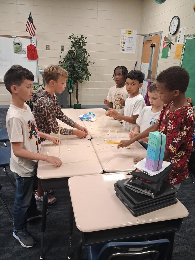 Students building out of marshmallows and noodles