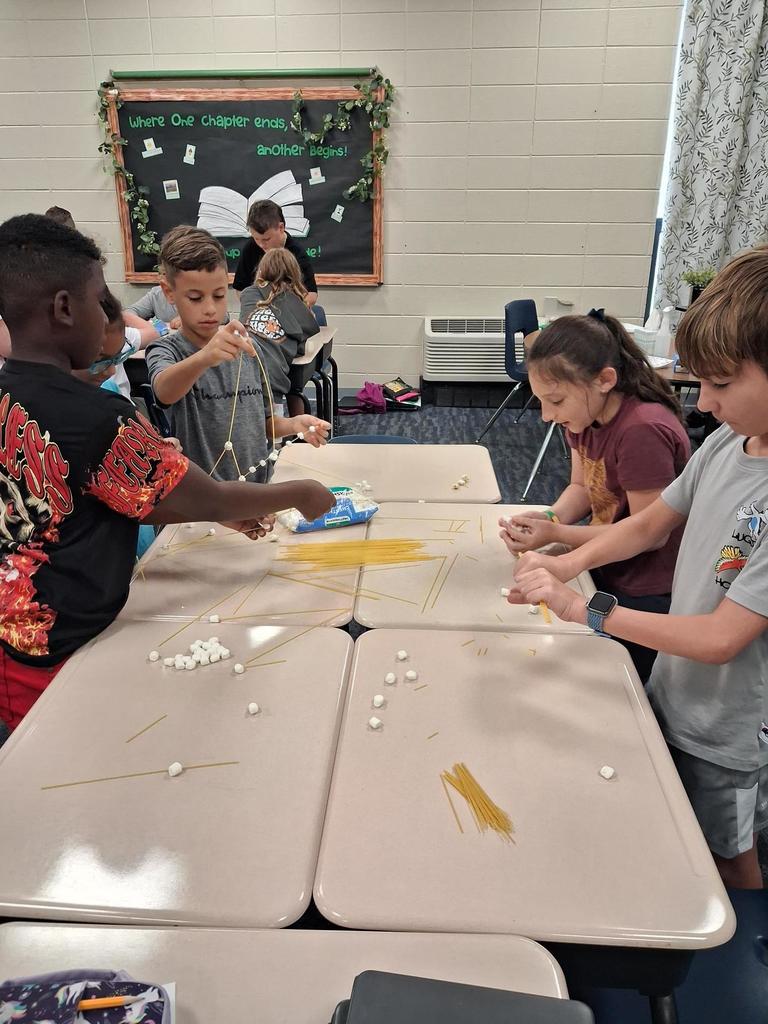 Students building out of marshmallows and noodles