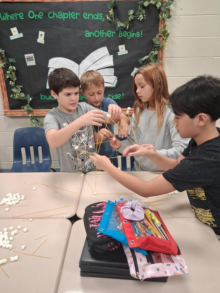 Students building out of marshmallows and noodles
