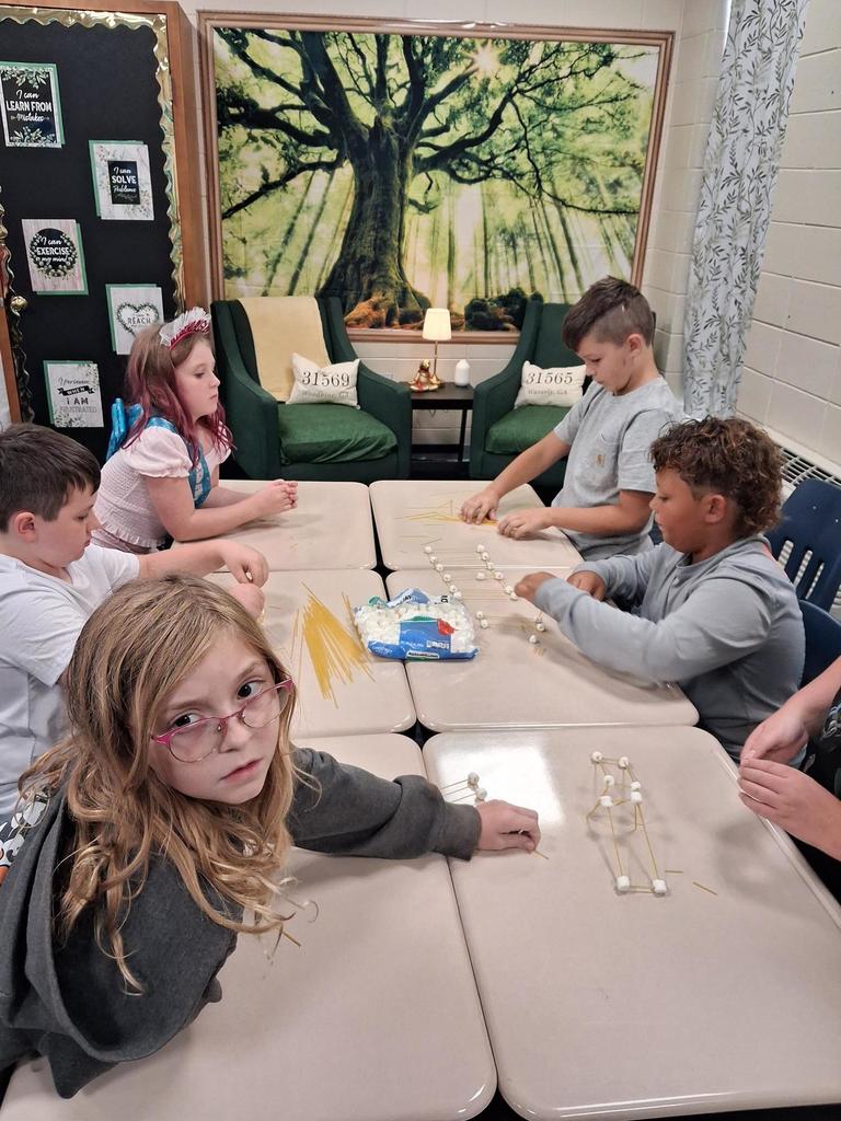 Students building out of marshmallows and noodles