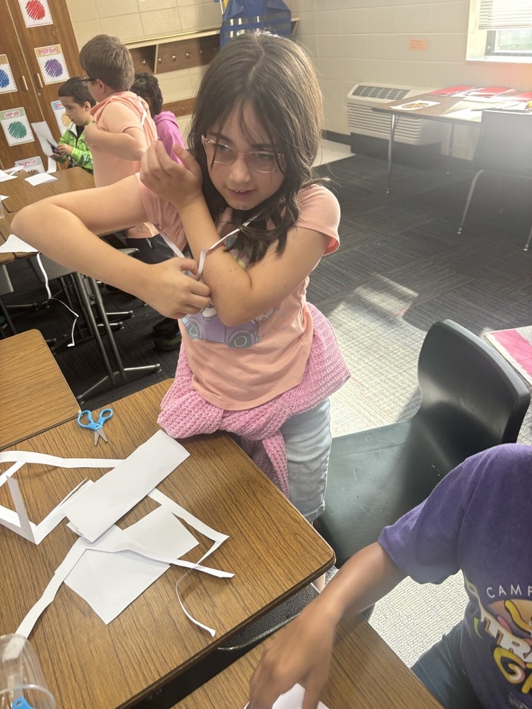 student fits through a piece of paper