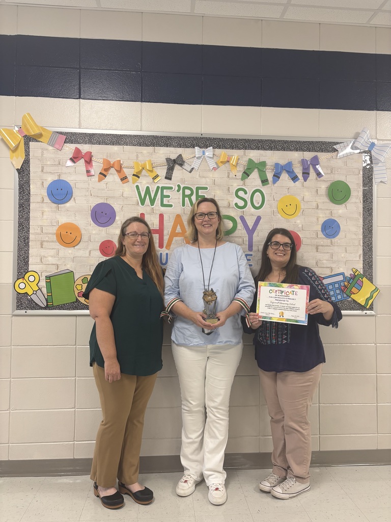 Camden County Public Library staff present the summer reading challenge trophy.