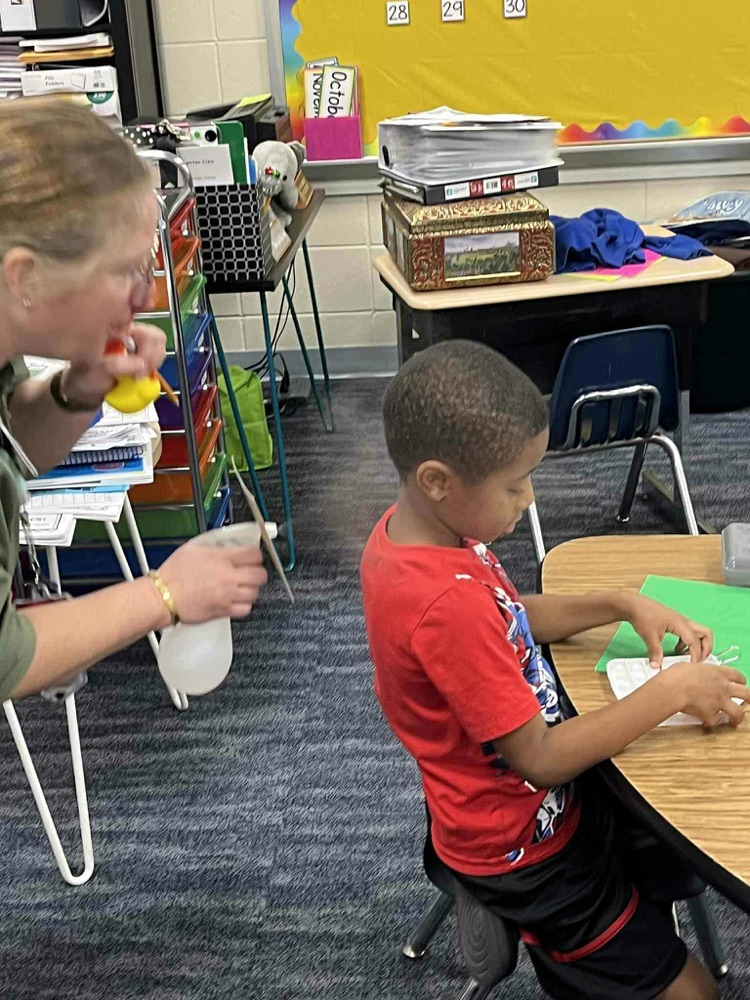 Nurse Kelly showing Kindergarten about hand washing
