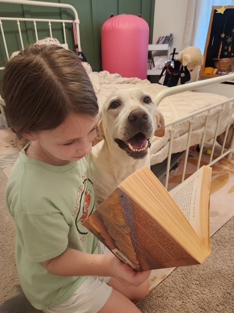 Girl reading to dog