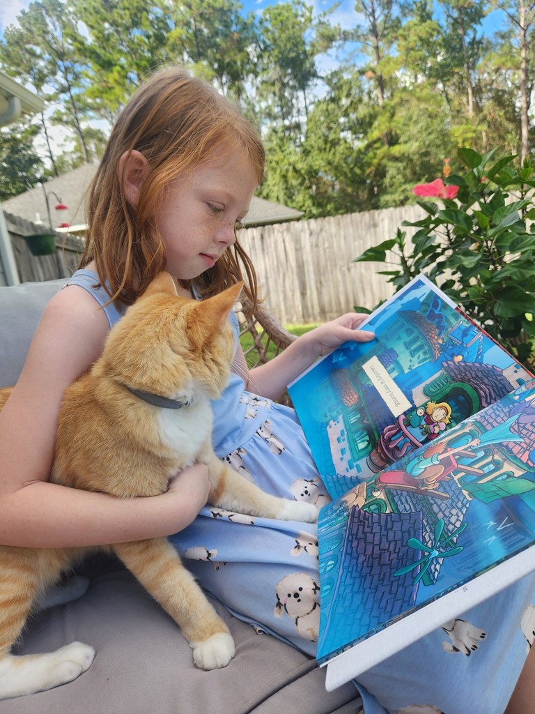 Girl reading to cat
