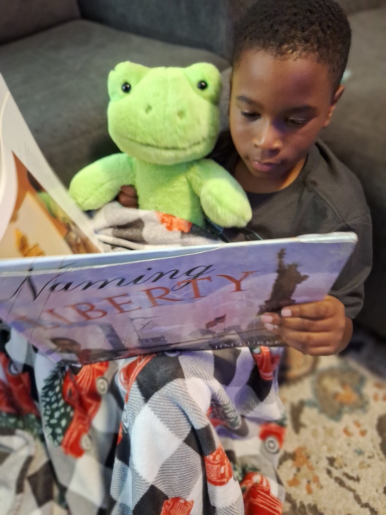 boy reading to stuffed animals