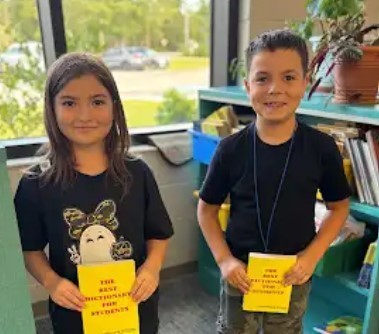 Students holding dictionaries.