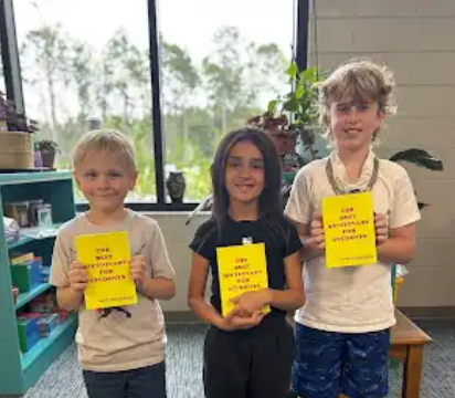Students holding dictionaries.