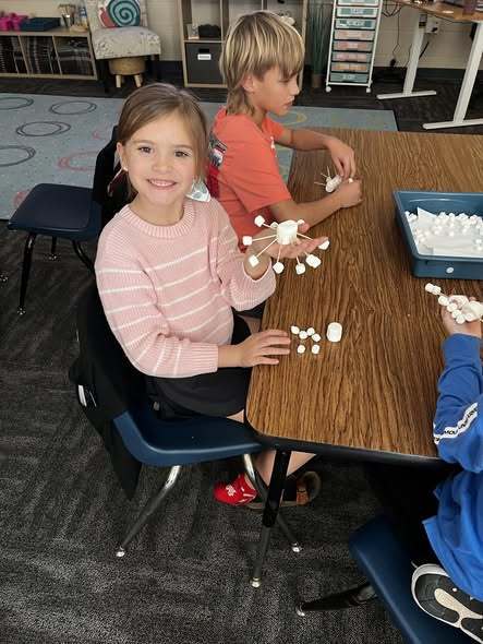 students working at tables doing project