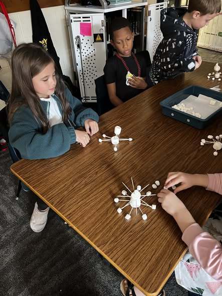 students working at tables doing project