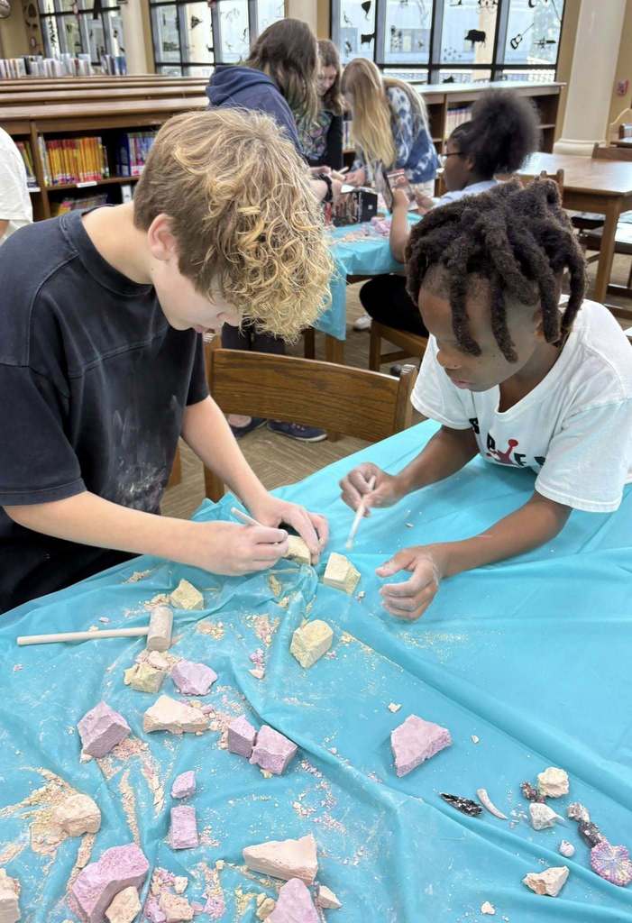 students digging through the rock