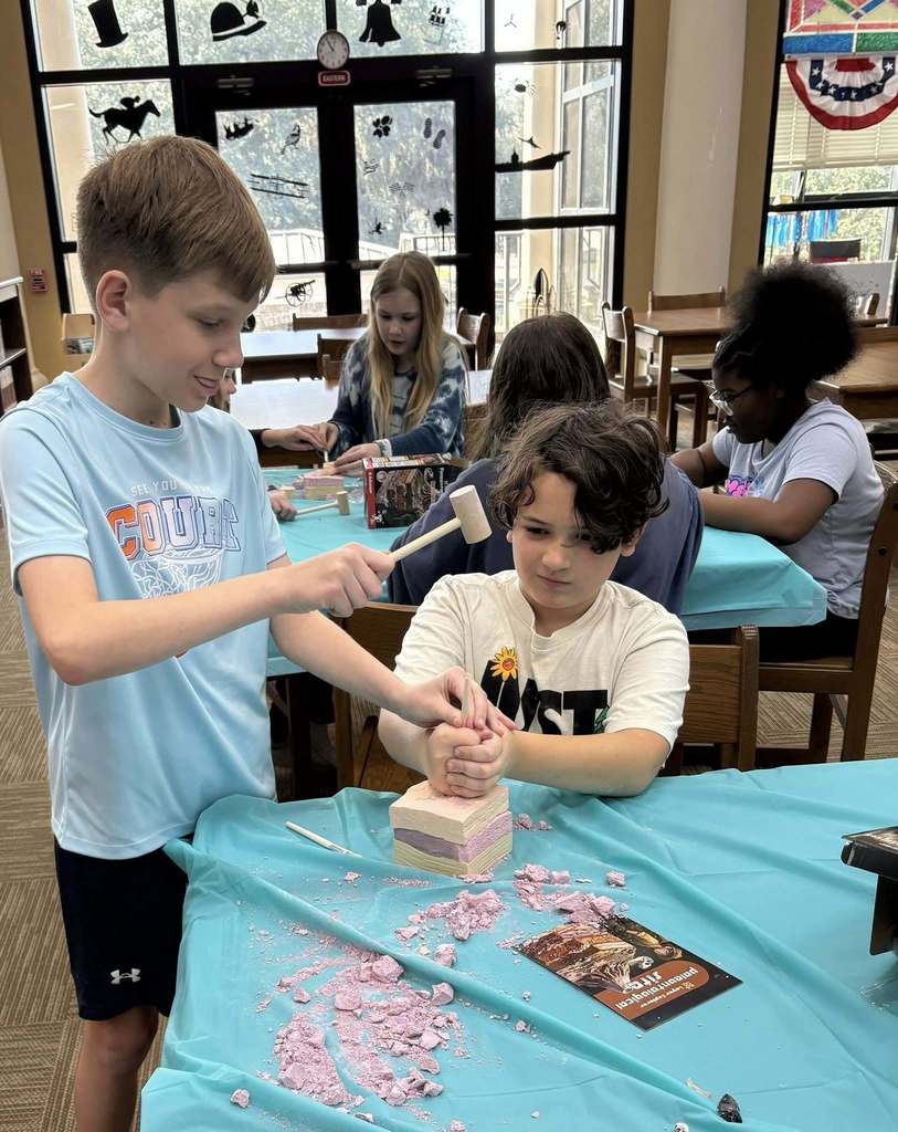 students digging through the rock
