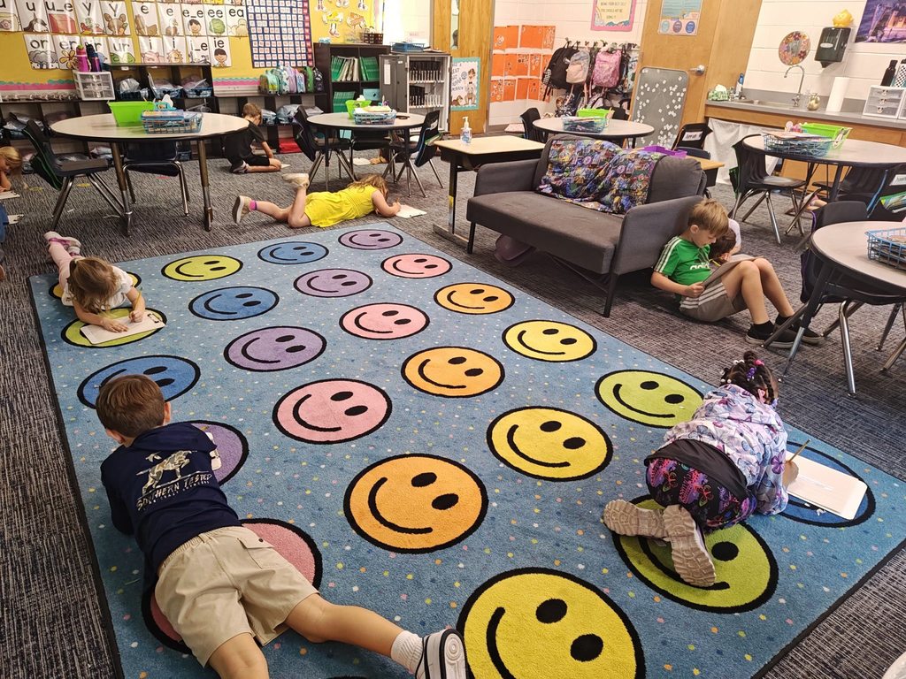 students working on their personal reflection from the activity in different areas of the room.