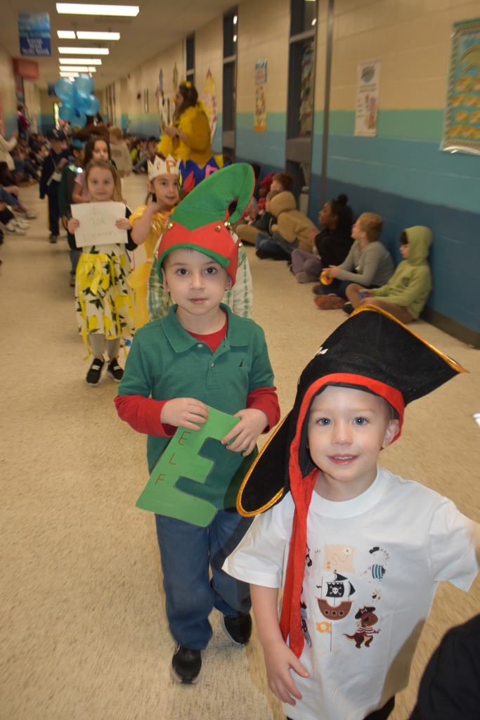 students walking in parade as many things like pirates and elves