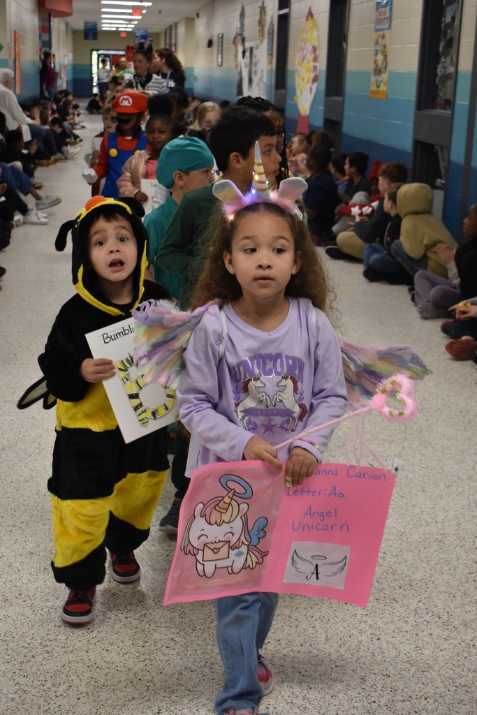 students walking in parade as many things, main girl in photo is a unicorn