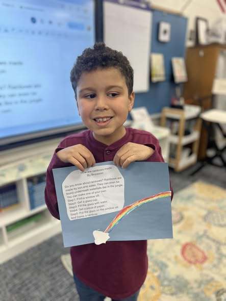 student holding up final project