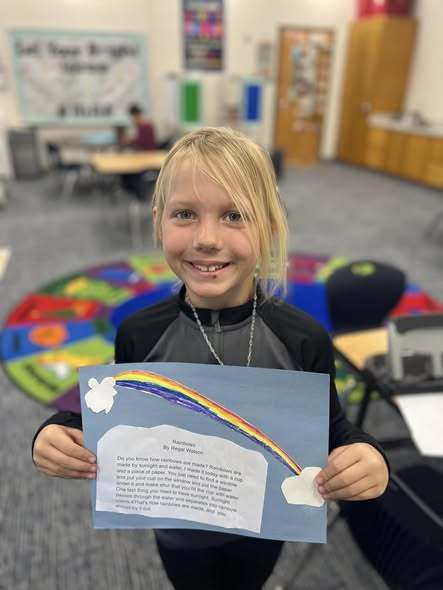 student holding up final project