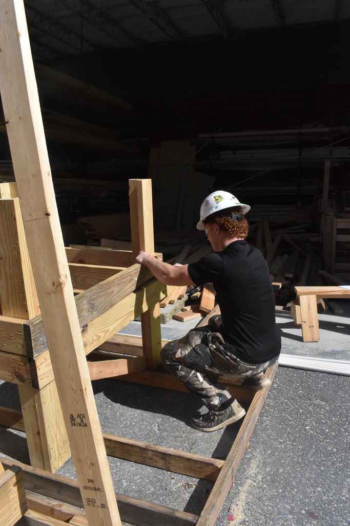 student screwing wood together