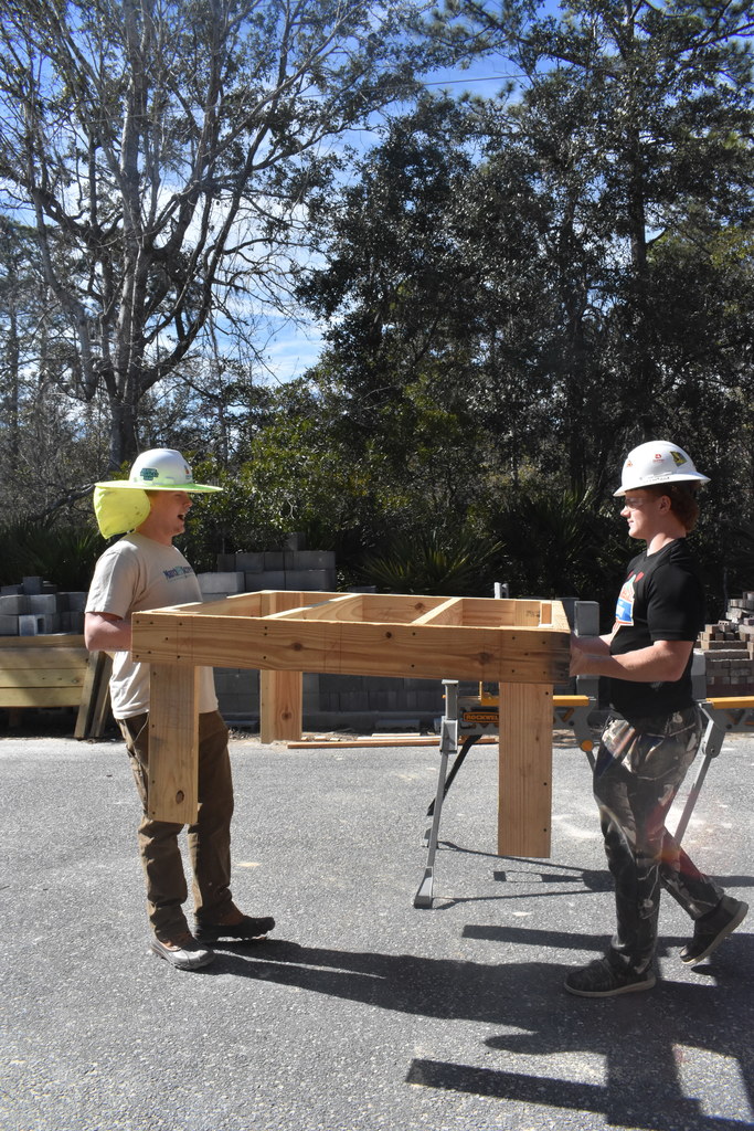 students carrying something they built