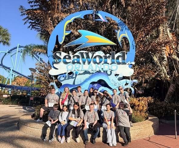 student group photo in front of sea world sign