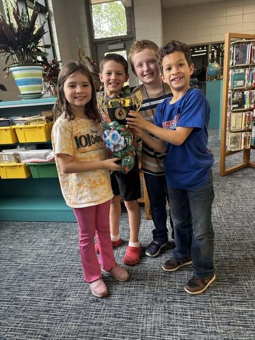 students holding trophy