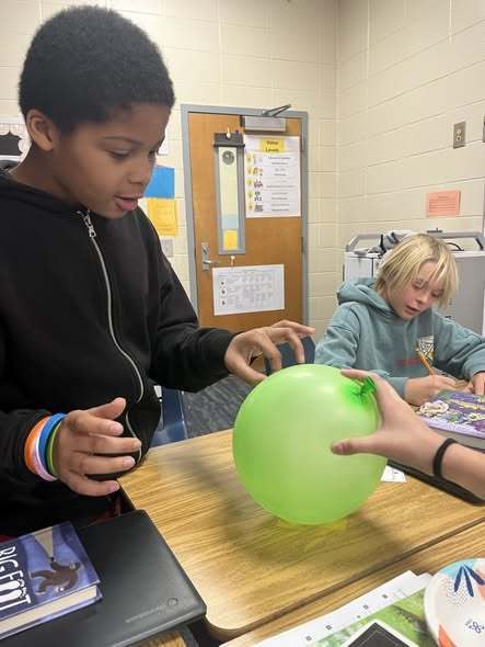 students working on assignment with balloons