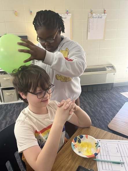 students working on assignment with balloons