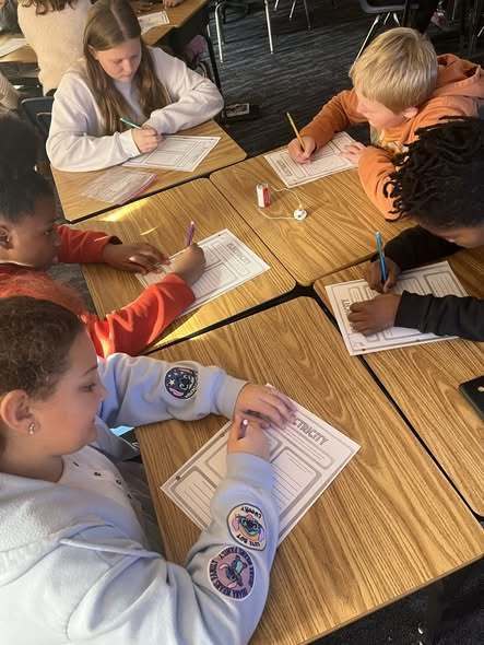 students working on assignment on paper