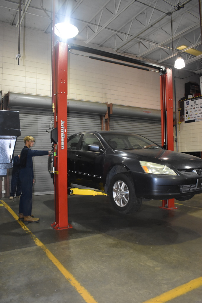 automotive student working with car