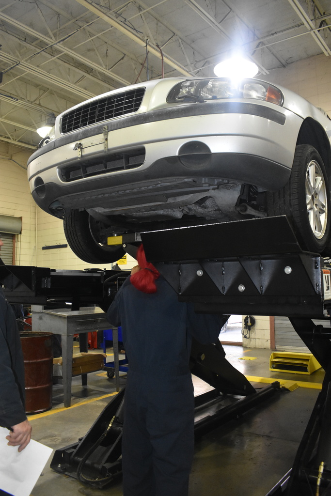automotive student working with car