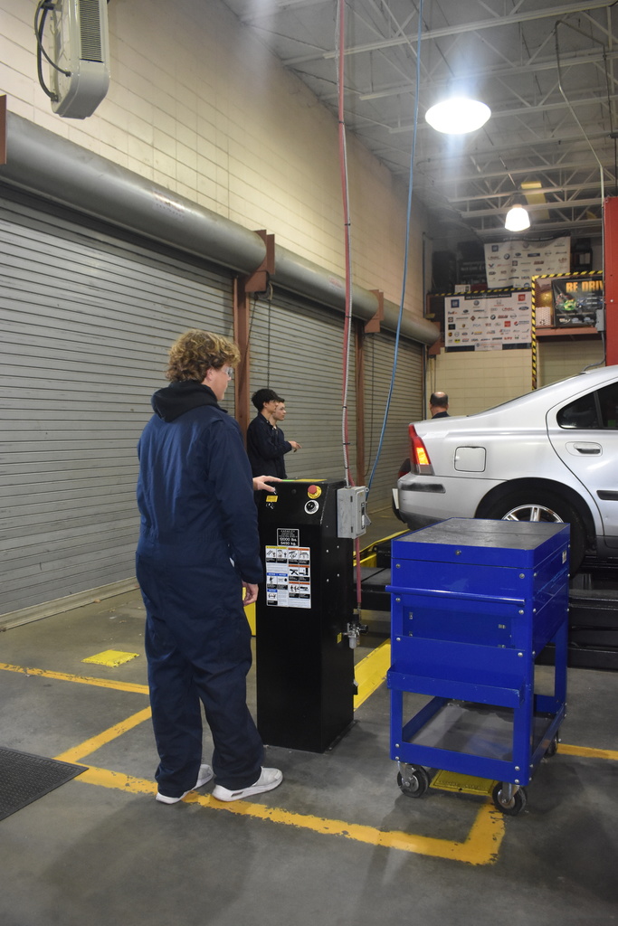 automotive student working with car