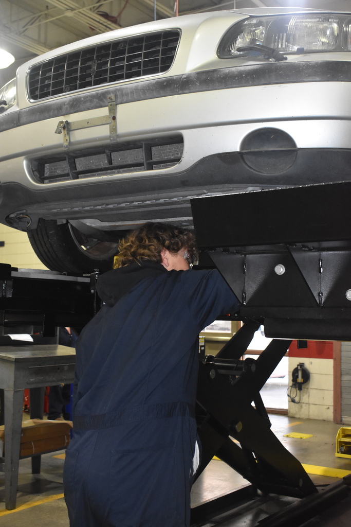 automotive student working with car