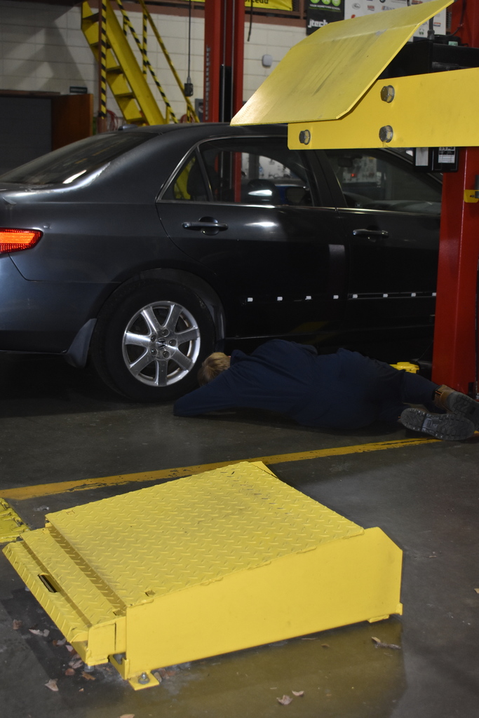 automotive student working with car