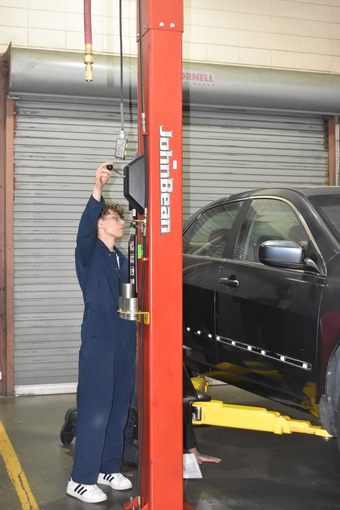 automotive student working with car