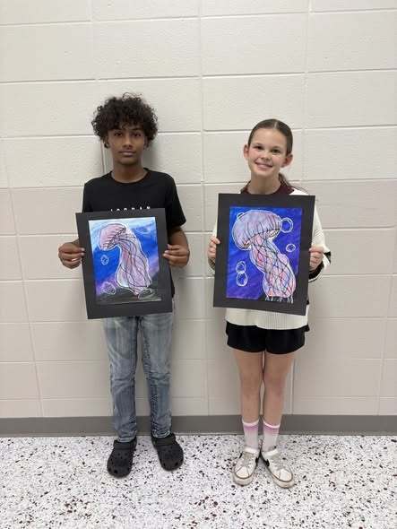 student with their artwork