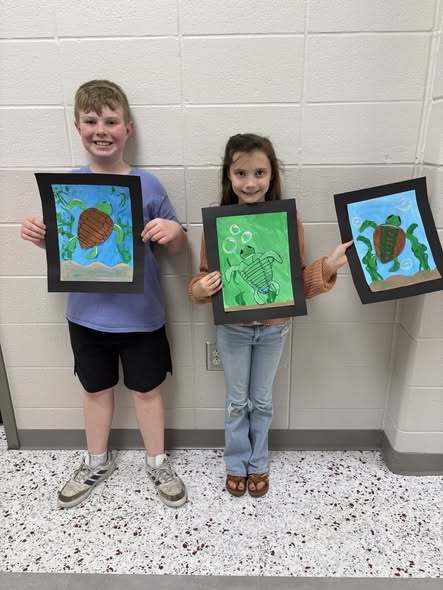 student with their artwork